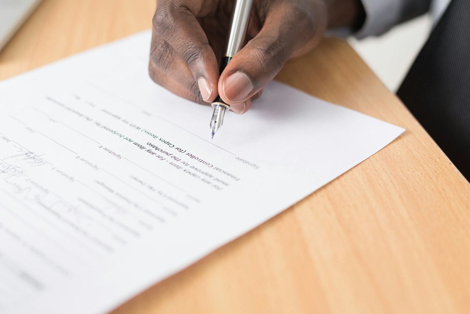 Hand signing a permit application document
